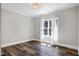 Bright bedroom features dark wood floors, crown molding and a large window at 4001 Belmont Forest Way, Raleigh, NC 27606