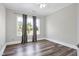 Bedroom with hardwood floors, natural light, and neutral colored walls and window treatments at 4001 Belmont Forest Way, Raleigh, NC 27606