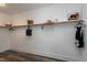 Walk-in closet with long white shelves for storing clothing and personal items at 4001 Belmont Forest Way, Raleigh, NC 27606