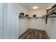 Spacious walk-in closet with built-in shelving, rod for hanging clothes, and neutral color palette at 4001 Belmont Forest Way, Raleigh, NC 27606
