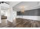 Open dining room features wainscoting, a modern chandelier, and wood floors at 4001 Belmont Forest Way, Raleigh, NC 27606