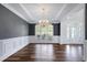 Bright dining room features wainscoting, a chandelier, and a decorative window at 4001 Belmont Forest Way, Raleigh, NC 27606