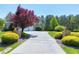 Long driveway leading to an attached garage with a basketball hoop at 4001 Belmont Forest Way, Raleigh, NC 27606