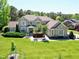 Beautifully landscaped brick home with a well-maintained lawn and mature trees at 4001 Belmont Forest Way, Raleigh, NC 27606