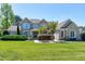 Stunning brick home featuring lush landscaping and a manicured lawn on a sunny day at 4001 Belmont Forest Way, Raleigh, NC 27606