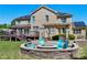 Inviting backyard firepit area with stone surround and colorful Adirondack chairs, perfect for relaxing at 4001 Belmont Forest Way, Raleigh, NC 27606