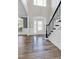 Welcoming foyer boasts beautiful floors, a decorative glass front door, and staircase details at 4001 Belmont Forest Way, Raleigh, NC 27606