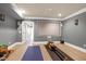 Basement workout room with a rower, projector screen, and custom wall decor at 4001 Belmont Forest Way, Raleigh, NC 27606