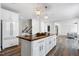 Bright kitchen with white cabinets, wood countertops on island, stainless steel appliances, and access to other rooms at 4001 Belmont Forest Way, Raleigh, NC 27606