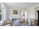 Cozy living area features modern chairs, stylish rug, and French doors at 4001 Belmont Forest Way, Raleigh, NC 27606