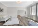 Bright living room with hardwood floors, large windows, and a cozy couch at 4001 Belmont Forest Way, Raleigh, NC 27606