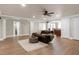 Spacious living room featuring a leather sofa, area rug, and open access to the kitchen at 4001 Belmont Forest Way, Raleigh, NC 27606