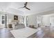 Airy primary bedroom featuring a tray ceiling, hardwood floors, and an abundance of natural light at 4001 Belmont Forest Way, Raleigh, NC 27606