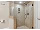 Luxurious tile shower featuring bronze fixtures, a glass door and neutral walls at 4001 Belmont Forest Way, Raleigh, NC 27606