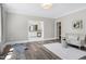 Sitting room featuring chair, hardwood floors, exercise mat, and adjacent bathroom for versatile use at 4001 Belmont Forest Way, Raleigh, NC 27606