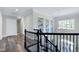 Bright staircase landing with stylish artwork and chandelier fixture enhances the home's aesthetic at 4001 Belmont Forest Way, Raleigh, NC 27606