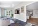 Bright sunroom with white chairs, patterned rug, tile floors, vaulted ceiling with skylight, and natural light at 4001 Belmont Forest Way, Raleigh, NC 27606