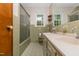 Retro bathroom with tiled walls, double vanity, and natural light from a window at 4298 Old Stage S Rd, Erwin, NC 28339