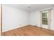Minimalist bedroom design with hardwood floors, a window, and white walls at 4298 Old Stage S Rd, Erwin, NC 28339