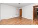 Bedroom featuring hardwood floors, a door, and a window to let in natural light at 4298 Old Stage S Rd, Erwin, NC 28339