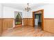 Charming dining room featuring wood floors, wainscoting, and a picturesque window view at 4298 Old Stage S Rd, Erwin, NC 28339