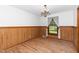 Traditional dining room with wood floors, wainscoting, and a decorative chandelier at 4298 Old Stage S Rd, Erwin, NC 28339