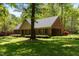 Beautiful brick home with a well-maintained lawn, mature trees, and warm lighting in the garage at 4298 Old Stage S Rd, Erwin, NC 28339