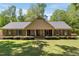 Inviting single-story brick home with a symmetrical design and manicured landscaping at 4298 Old Stage S Rd, Erwin, NC 28339