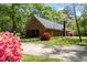 Charming brick home with lush landscaping, driveway, and attached garage at 4298 Old Stage S Rd, Erwin, NC 28339