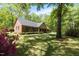 Beautiful brick house with blooming azaleas and mature trees creating a serene setting at 4298 Old Stage S Rd, Erwin, NC 28339