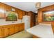Functional kitchen features wood cabinets and a long island with a white countertop at 4298 Old Stage S Rd, Erwin, NC 28339