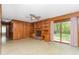 Cozy living room with wood paneling, a brick fireplace, and sliding glass doors to the outside at 4298 Old Stage S Rd, Erwin, NC 28339