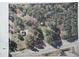 Aerial view of a property with red boundary lines, highlighting the lot within a forested area with nearby residences at 4501 Duraleigh Rd, Raleigh, NC 27612