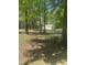 Exterior of the home with a covered front porch nestled amongst the trees at 4501 Duraleigh Rd, Raleigh, NC 27612