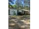 Ranch-style home with white awnings, brick accents, and flowering bushes at 4501 Duraleigh Rd, Raleigh, NC 27612
