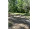 A mostly cleared building site with mature trees and grassy areas at 4501 Duraleigh Rd, Raleigh, NC 27612