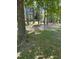 View of the lot and outbuilding with shade trees on the property at 4501 Duraleigh Rd, Raleigh, NC 27612