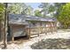 Inviting back deck perfect for entertaining or relaxing amidst a serene wooded backdrop at 500 W Woodcroft Pkwy # 13D, Durham, NC 27713
