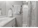 Clean bathroom showcases a shower with a patterned curtain, white towels, and crisp white walls at 500 W Woodcroft Pkwy # 13D, Durham, NC 27713