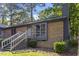 Brick house featuring a welcoming staircase to the front door and lush, green landscaping at 500 W Woodcroft Pkwy # 13D, Durham, NC 27713