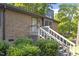 Lovely brick home showing the walkway to the front door, framed by green bushes and trees at 500 W Woodcroft Pkwy # 13D, Durham, NC 27713