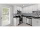 Bright kitchen features stainless steel appliances, granite countertops, and stylish backsplash at 500 W Woodcroft Pkwy # 13D, Durham, NC 27713