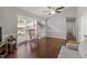 Spacious living room featuring large windows, a ceiling fan, and hardwood floors at 500 W Woodcroft Pkwy # 13D, Durham, NC 27713