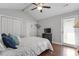 Bright main bedroom with closet, ceiling fan and sliding glass door to backyard at 500 W Woodcroft Pkwy # 13D, Durham, NC 27713