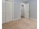 Carpeted bedroom features double closets and neutral wall color at 500 W Woodcroft Pkwy # 17C, Durham, NC 27713