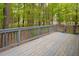 View of wood deck and wooded backyard, offering privacy at 500 W Woodcroft Pkwy # 17C, Durham, NC 27713