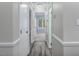 Hallway features new floor and leads to brightly lit rooms at 500 W Woodcroft Pkwy # 17C, Durham, NC 27713