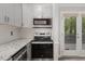 Updated kitchen features stainless appliances, granite counters, and backyard access to deck at 500 W Woodcroft Pkwy # 17C, Durham, NC 27713