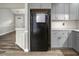 Bright kitchen featuring gray cabinets, granite counters, stainless appliances and wood-look flooring at 500 W Woodcroft Pkwy # 17C, Durham, NC 27713