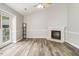 Spacious living room featuring wood-look flooring, fireplace, and lots of natural light at 500 W Woodcroft Pkwy # 17C, Durham, NC 27713